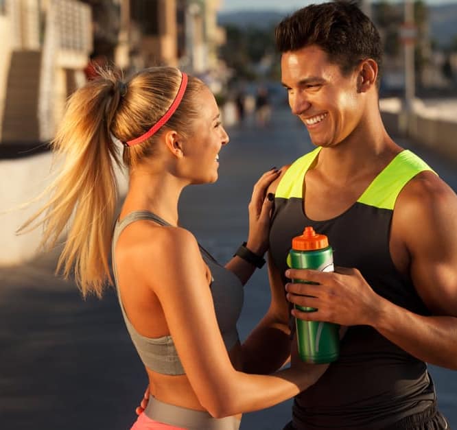 couple looking at each other wearing workout outfits