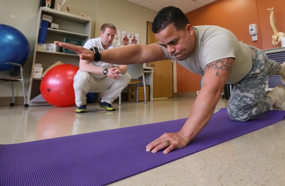 man having a workout session with his trainer
